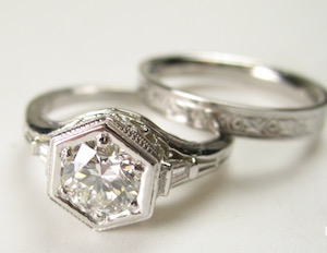 Antique silver engagement ring with hexagonal  center stone and diamonds in the band. 