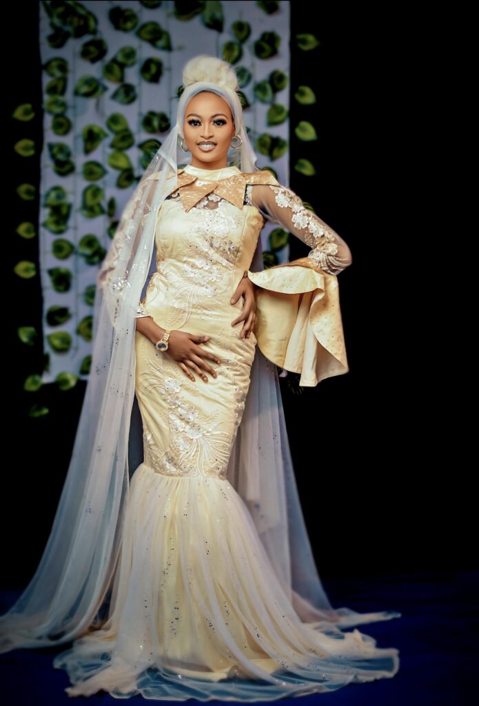 Blonde African American bride in a fitted ivory mermaid wedding dress with appliqued sleeves