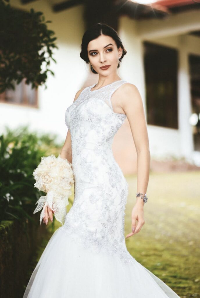 Dark haired bride in a fitted brocade mermaid wedding dress