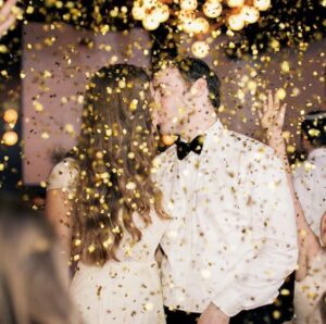 Bride and groom kissing during a confetti send off