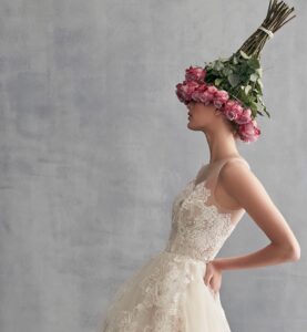 bride with pink floral bouquet on top of her head