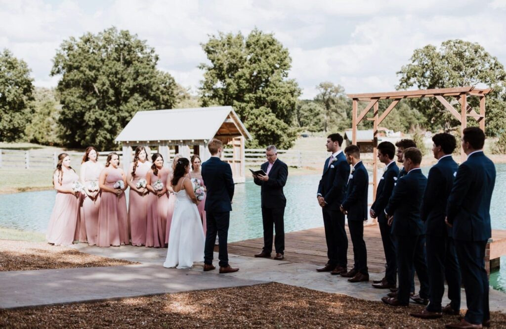 A beautiful summer wedding at Steel Magnolia Barn with a lakeside wedding ceremony of blush and navy.