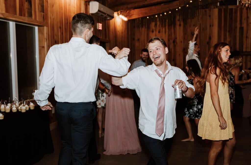 Two men dancing at a summer wedding at Steel Magnolia Barn
