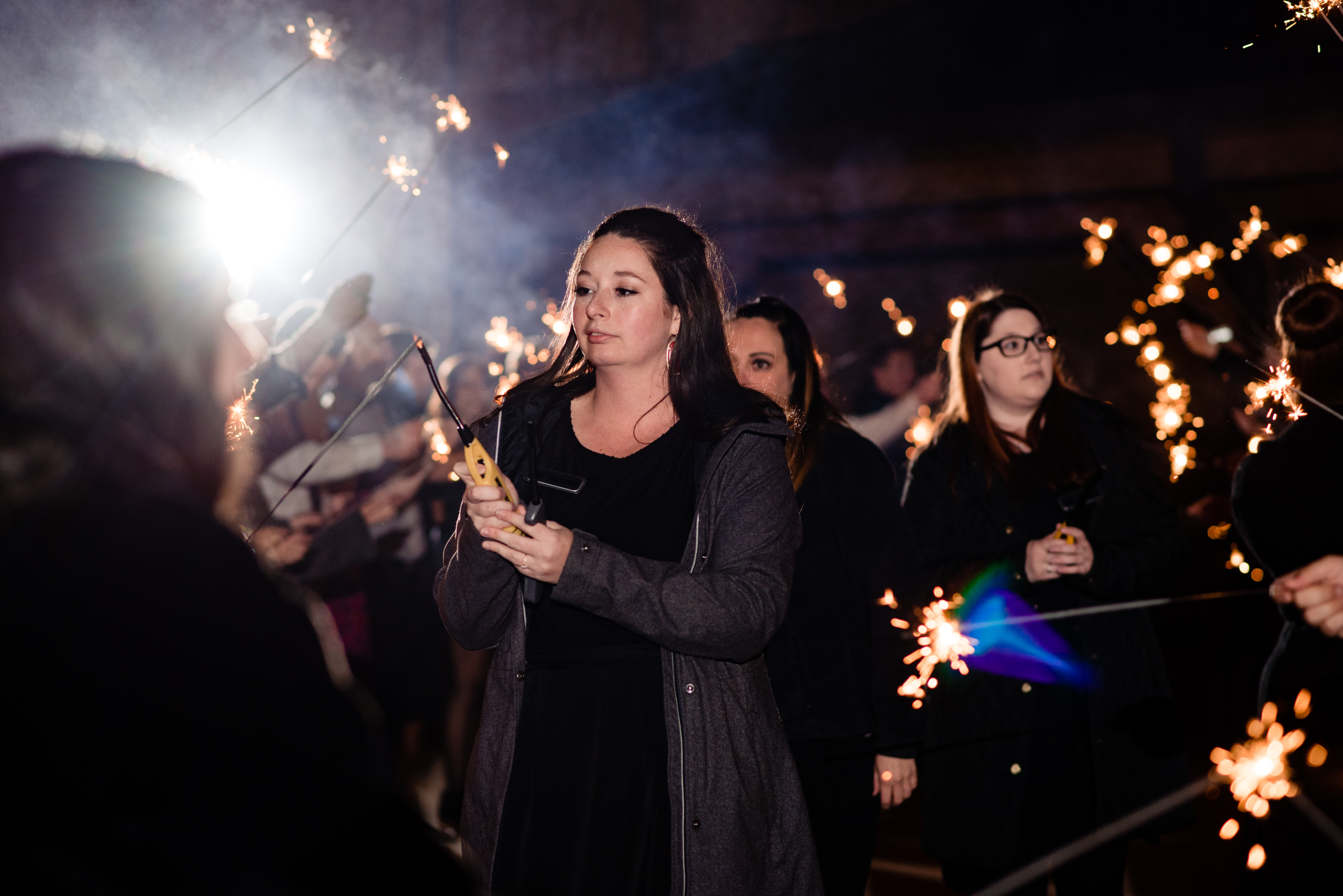 Mariah, lead planner at Weddings and Events by Raina lighting sparklers at Arrington Vineyard wedding.