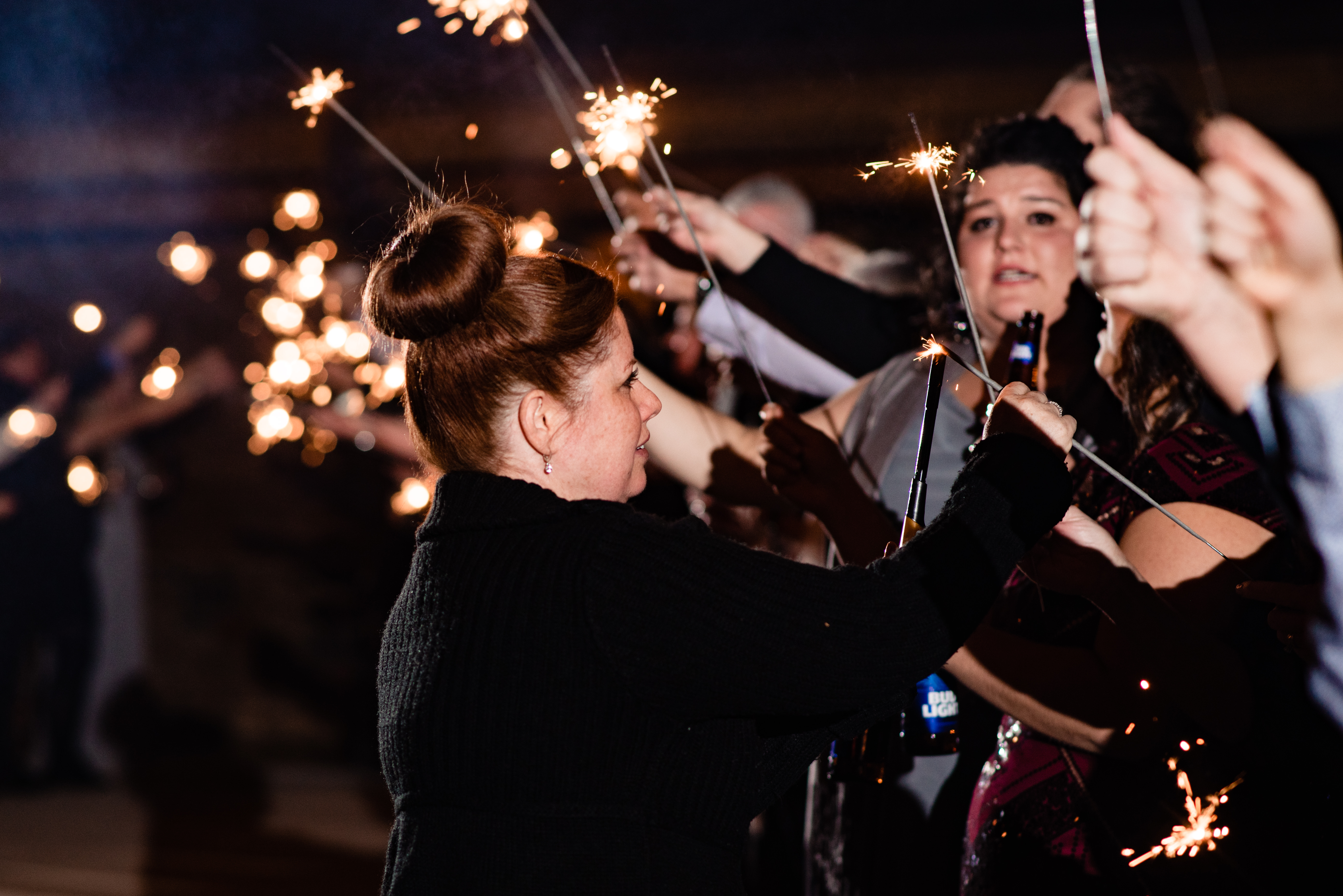 Raina, owner and lead planner of Weddings and Events by Raina lighting sparklers at Arrington Vineyard wedding.