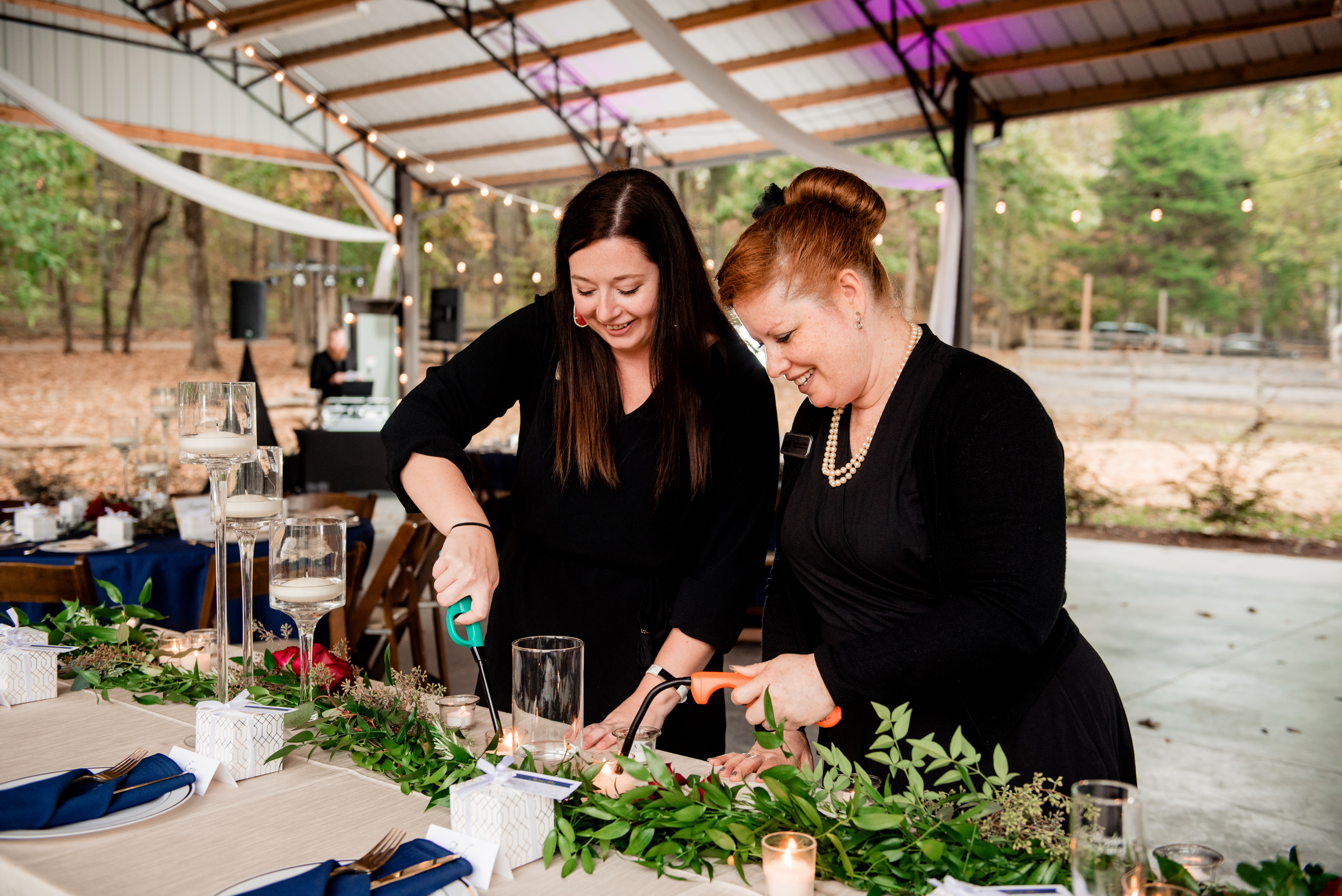 Raina, owner and lead planner of Weddings and Events by Raina and team member Mariah at vineyard wedding.