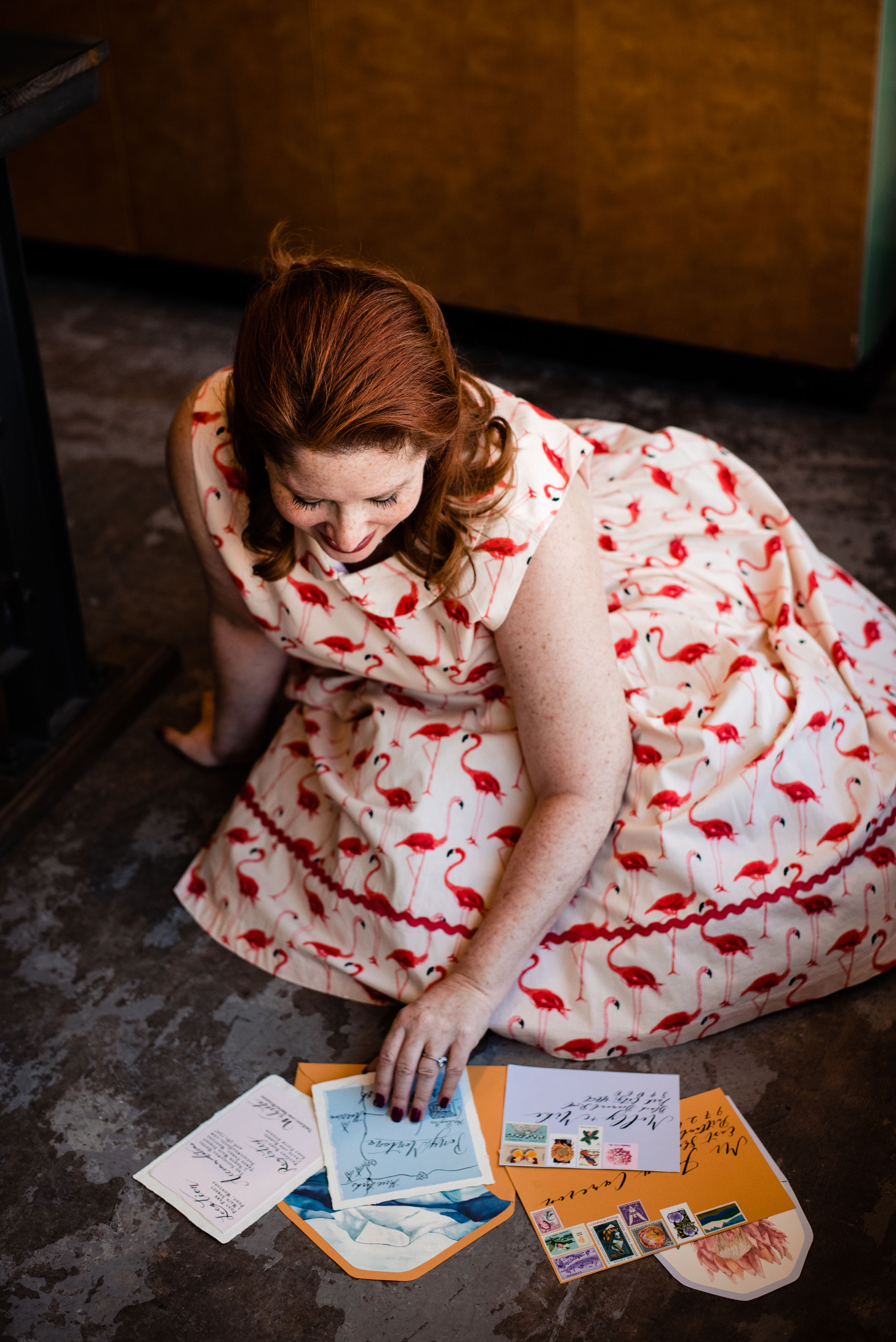 Raina, owner and lead planner of Weddings and Events by Raina organizing wedding invitations to be sent out.