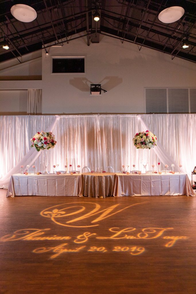 Pink and white wedding reception at Noah Liff Opera Center in Nashville Tennessee with drapery and a monogram gobo on the dance floor