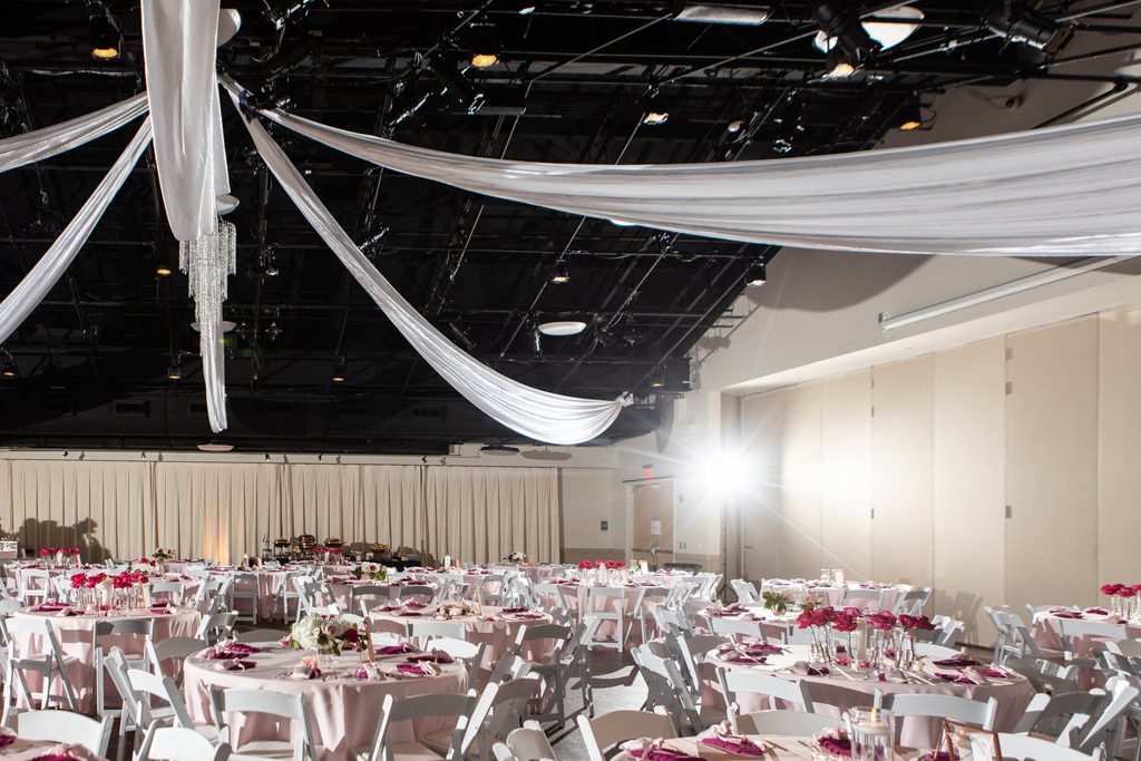 Pink and white wedding reception at Noah Liff Opera Center in Nashville Tennessee with ceiling drapery
