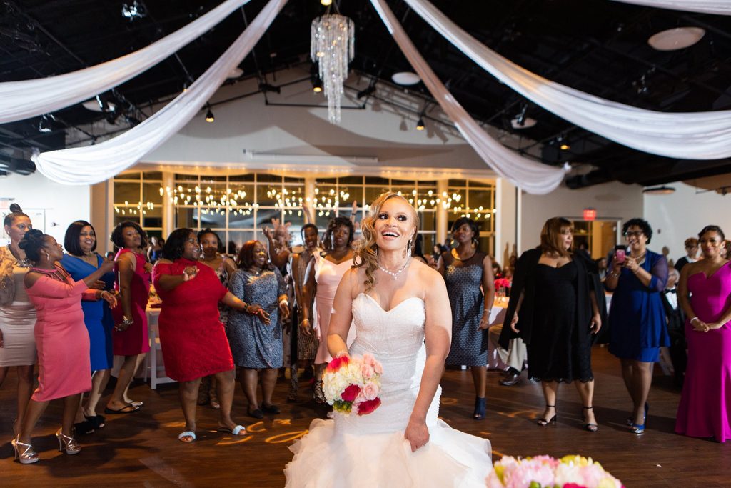 Bride tossing the bouquet at her wedding reception at Noah Liff Opera Center in Nashville Tennessee