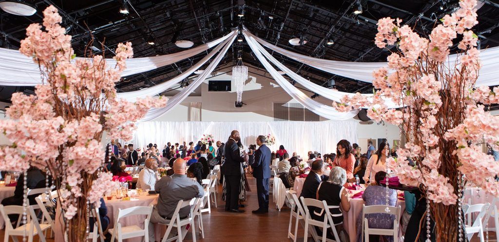Elegant spring wedding reception at Noah Liff Opera Center in Nashville Tennessee with ceiling drapery and pink florals. 