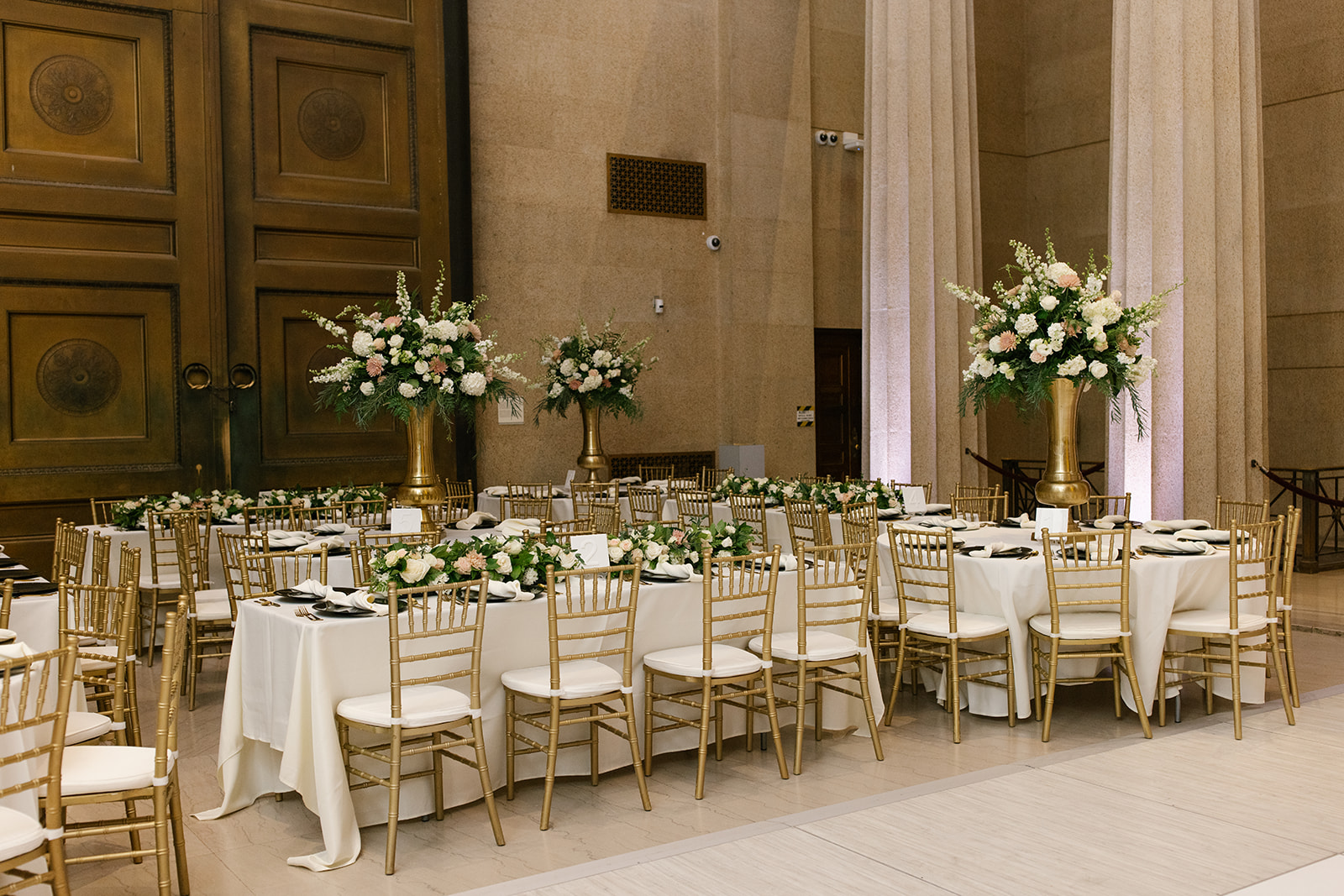 Elegant wedding reception florals in ivory, peach and gold at The Parthenon in Nashville, Tennessee