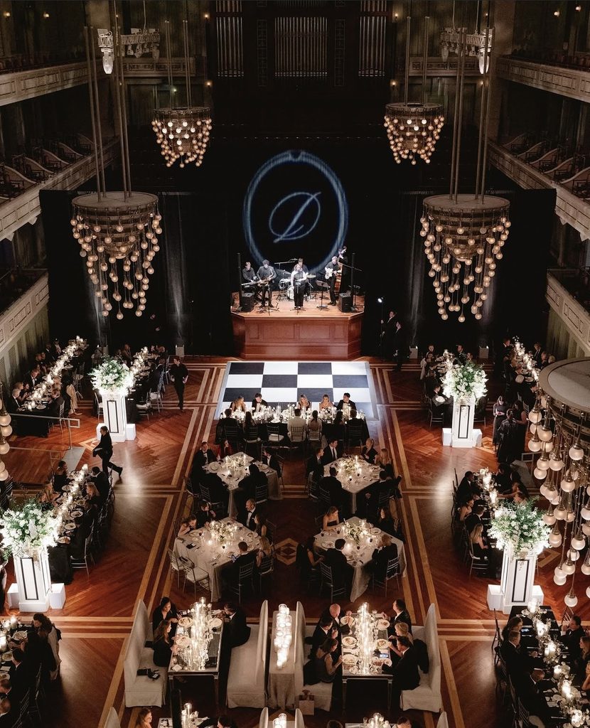 An elegant wedding reception with a checkerboard dance floor at the Schermerhorn Symphony Center in Nashville, Tennessee