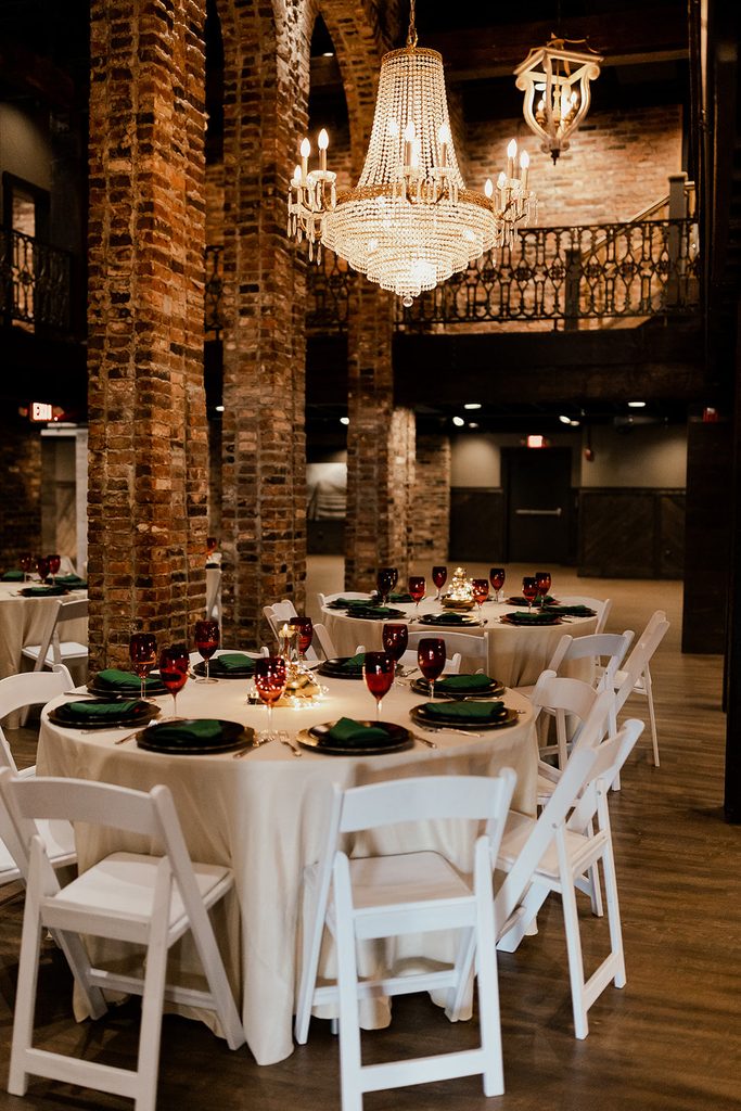 An elegant wedding at The Bedford Nashville Event Venue with crystal chandeliers, exposed brick and hardwood floors. 
