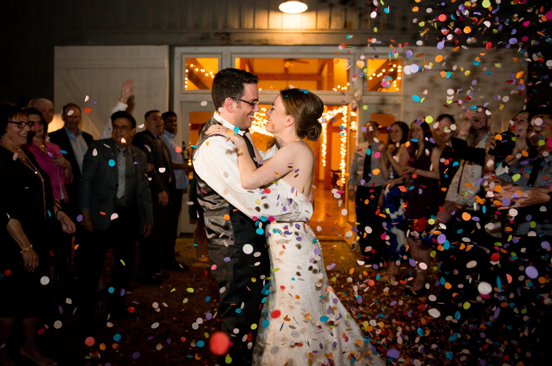 Bride and groom embrace during their end of the night confetti send off